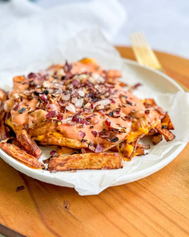 To assemble the animal style fires, transfer the fries to your serving dish, top with the sauce and then sprinkle on the onions.